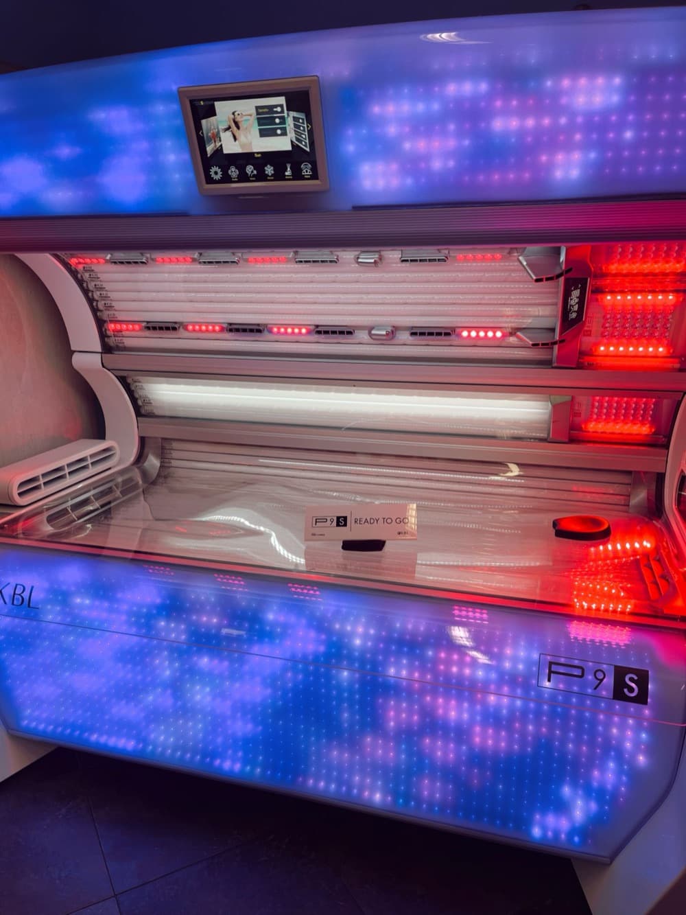 KBL P9S tanning bed with its lamps on, ready to go